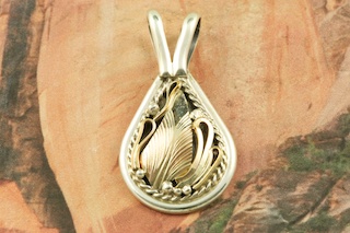 Stunning Sterling Silver Pendant featuring 12K Gold Fill Designs. Created by Navajo Artist Justin Morris. Signed by the artist. Justin Morris incorporates meaning in his Sterling Silver Designs. The Sterling Silver Shell represents Protection, the Circle of Life represents Balance and the Raindrops represent Abundance. Free 18
